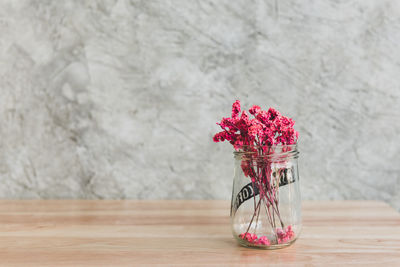 Red flowers in vase on table