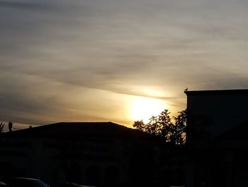 Low angle view of silhouette building against sky at sunset