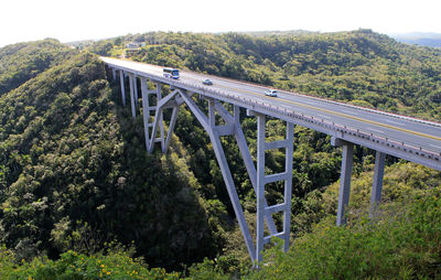 Bridge over mountain against sky