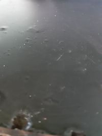 High angle view of raindrops on lake