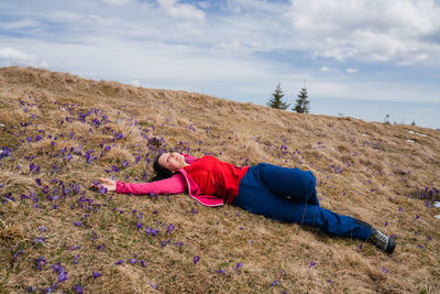 Rear view of woman sitting on mountain