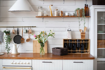 Light cozy wooden kitchen. kitchenware. kitchen interior in apartment. utensils on the wall