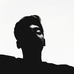 Close-up portrait of silhouette man against white background