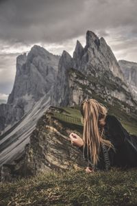 Woman on mountain range against sky