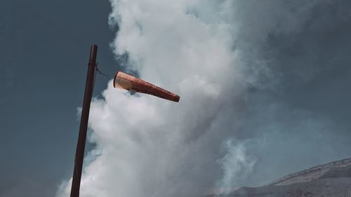 Low angle view of telephone pole against sky