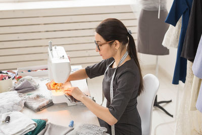 Side view of woman working in office