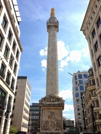 Low angle view of building against cloudy sky