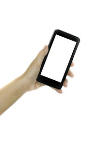 Close-up of hand using mobile phone against white background