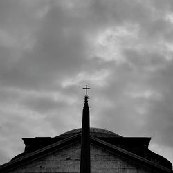 Low angle view of cross against cloudy sky