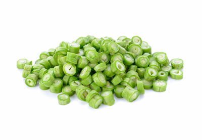 Close-up of green chili pepper against white background