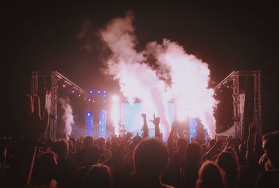 People watching firework display at night