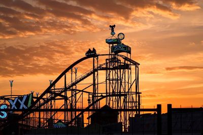 Silhouette statue against sky during sunset