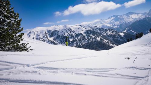 Scenic view of snow covered mountains against sky