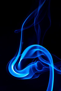 Close-up of light painting against black background