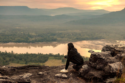 Man looking at view of mountain range