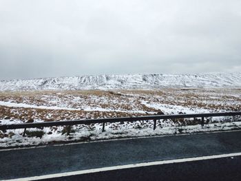 Snow covered landscape seen through from road