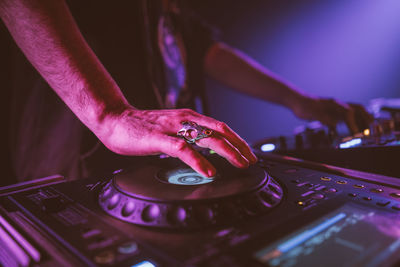 Midsection of person using smart phone at night