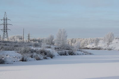 Snow covered field against sky