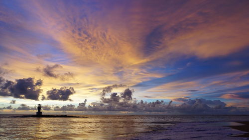 Scenic view of beach against sky during sunset