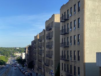 Street amidst buildings against sky in city during summer 2020 view from white plains road new york 