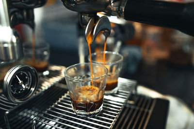 Close-up of wine pouring coffee in glass