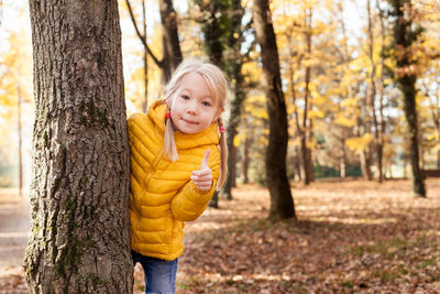 Portrait of smiling boy in forest during autumn