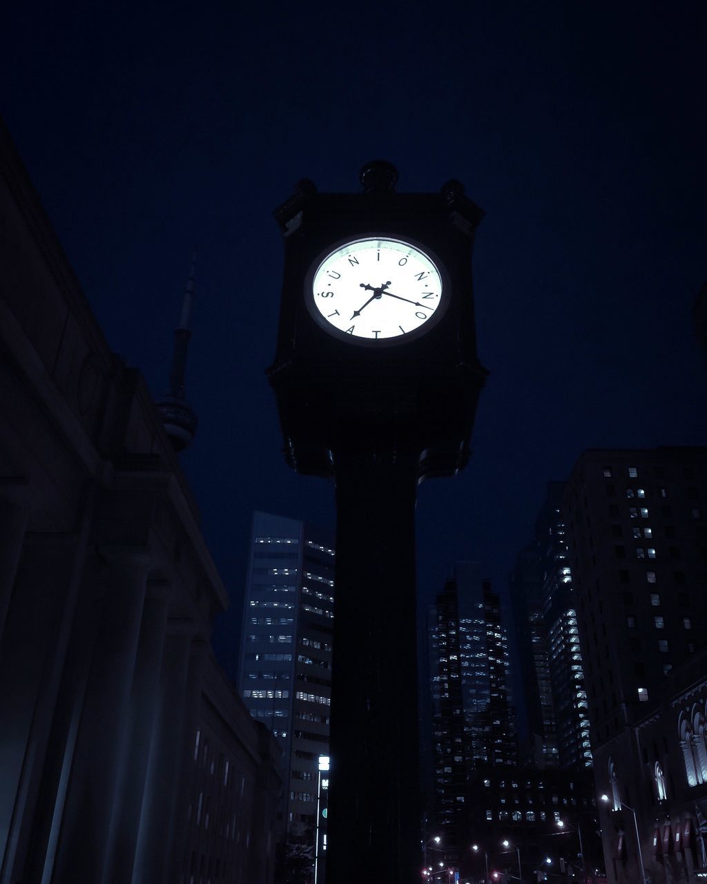 architecture, built structure, building exterior, illuminated, low angle view, night, city, tower, tall - high, clock tower, clear sky, clock, sky, time, skyscraper, lighting equipment, building, modern, window, no people