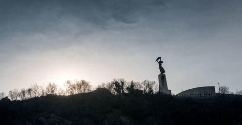 Low angle view of statue against sky