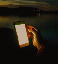 Close-up of silhouette woman using mobile phone