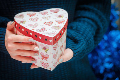 Midsection of woman holding gifts