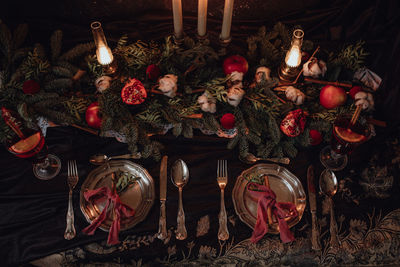 Christmas academia vintage romantic table with fir, candles, mulled wine, red decorations