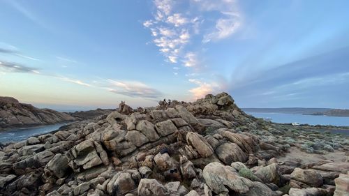 Rocks on beach against sky