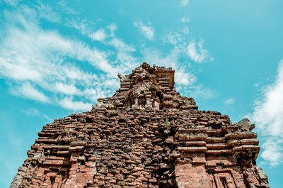 Low angle view of old temple against cloudy sky