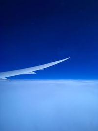 Airplane flying over blue sky