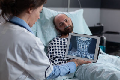 Doctor looking at medical xray of patient in hospital