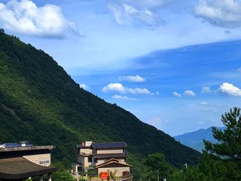 Scenic view of buildings and mountains against sky
