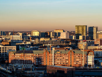 High angle view of buildings in city against sky during sunset