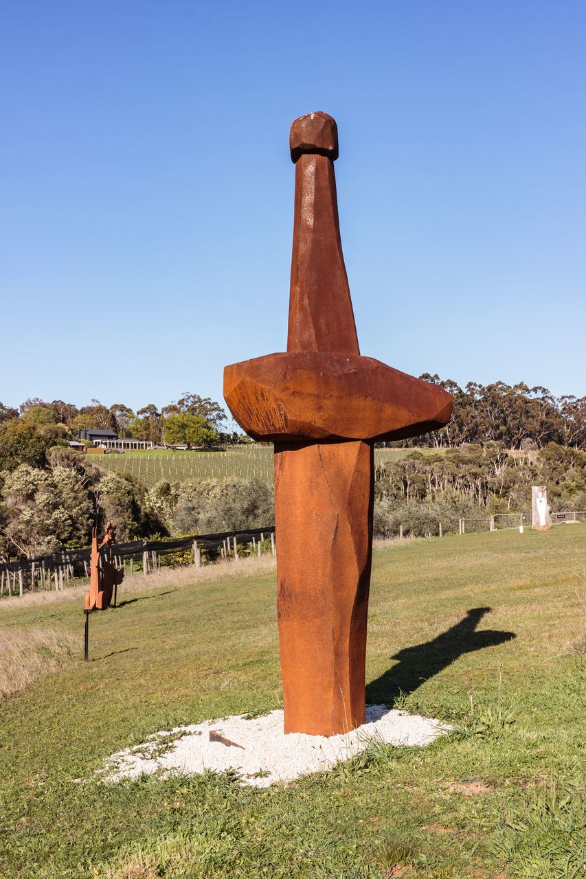 SCULPTURE ON FIELD AGAINST CLEAR SKY