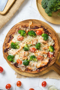 High angle view of pizza served on table