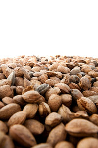 Close-up of roasted coffee beans against white background