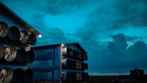 Low angle view of farm buildings against sky at night