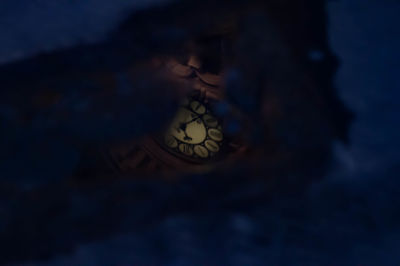 Low angle view of clock at night