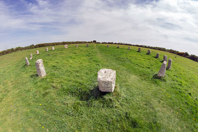 Scenic view of old ruin on field against sky
