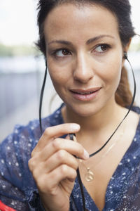 Businesswoman smiling while looking away outdoors