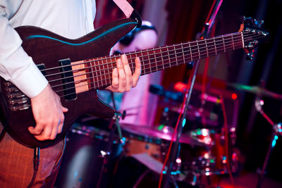 Midsection of man with guitar