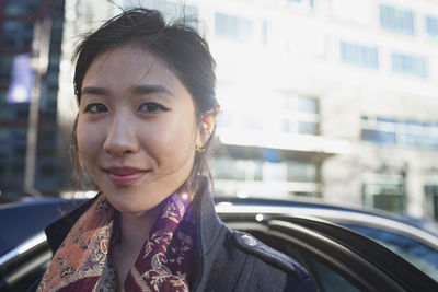 Young asian businesswoman looking in camera in urban environment