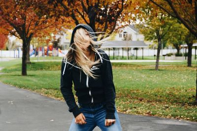 Rear view of woman standing in park