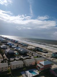 High angle view of buildings by sea against sky