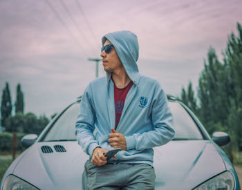 Full length of man standing by car