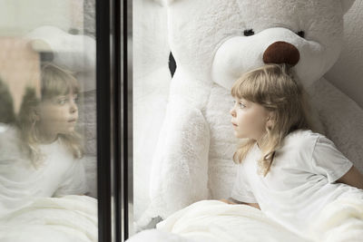 Girl looking through window